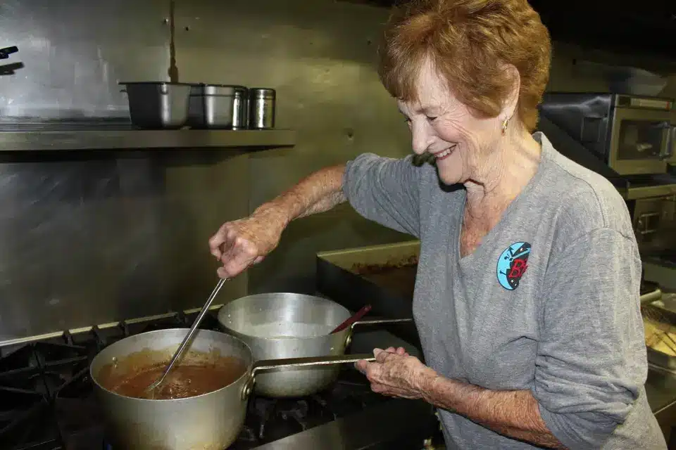 Elderly woman cooking in kitchen